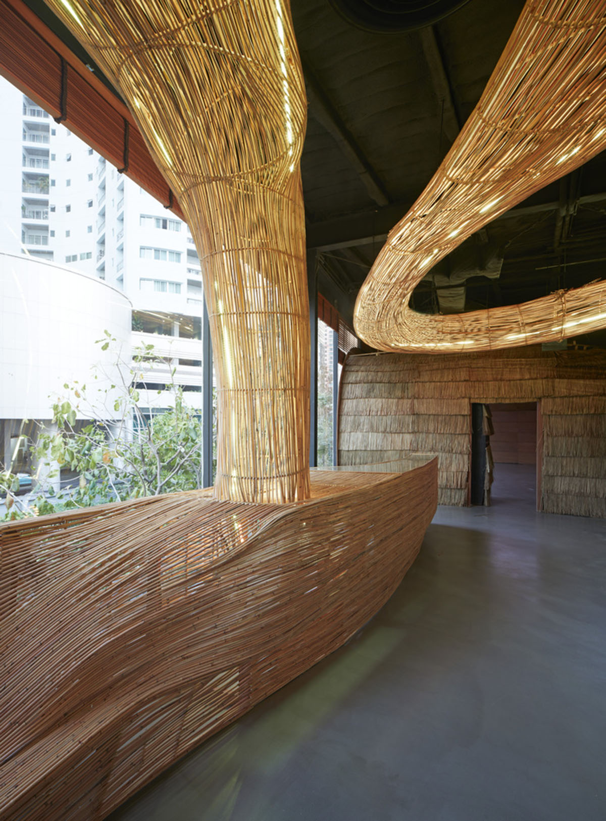 Free form wooden pods wrap the interior of yoga space in Bangkok designed by Enter Projects Asia