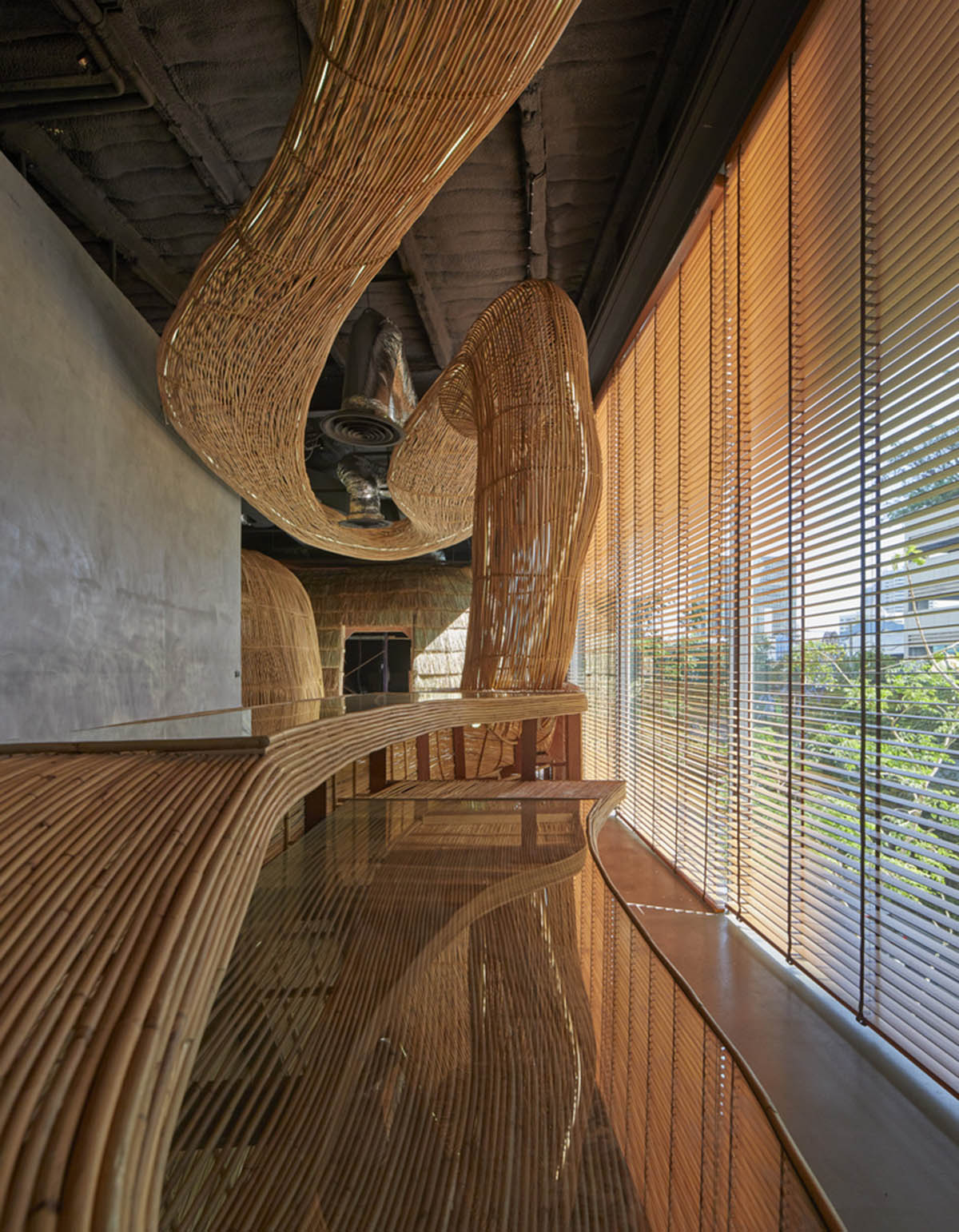 Free form wooden pods wrap the interior of yoga space in Bangkok designed by Enter Projects Asia