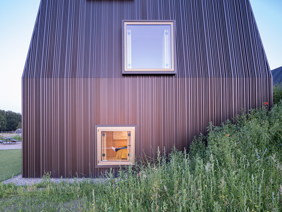 Mecanoo completes Villa Vught with dark bronze cladding inspired by traditional Dutch farmhouses