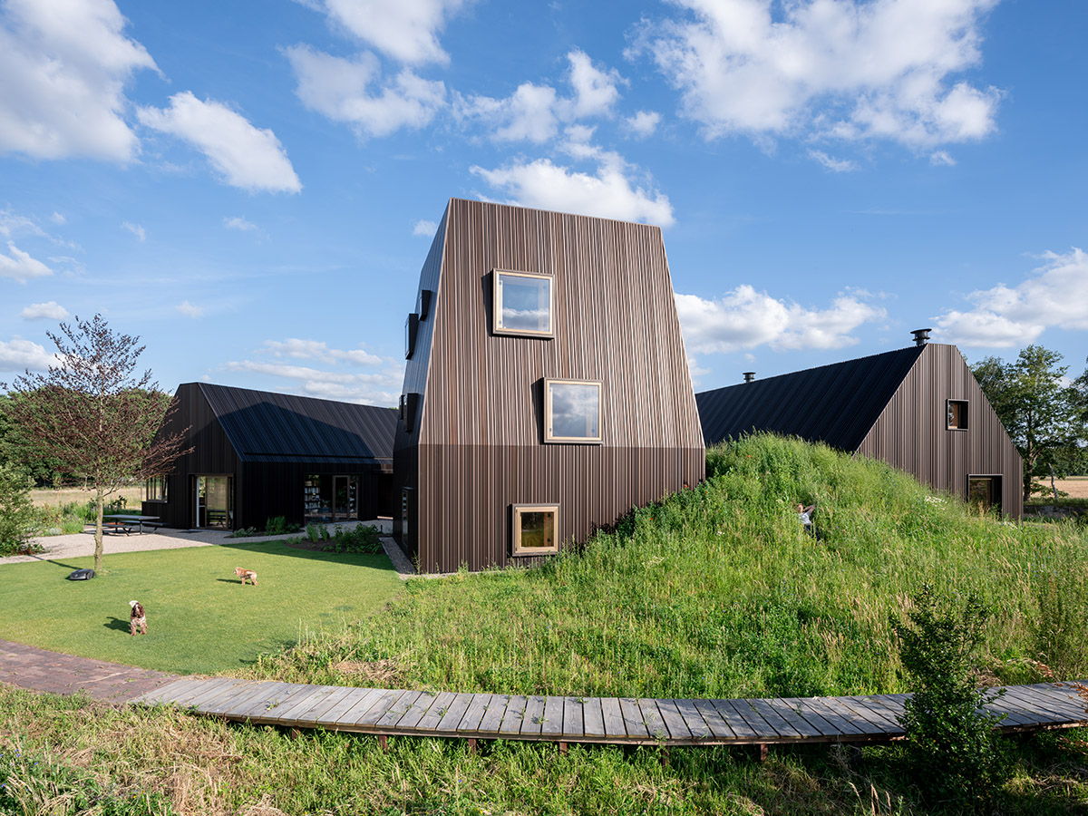 Mecanoo completes Villa Vught with dark bronze cladding inspired by traditional Dutch farmhouses