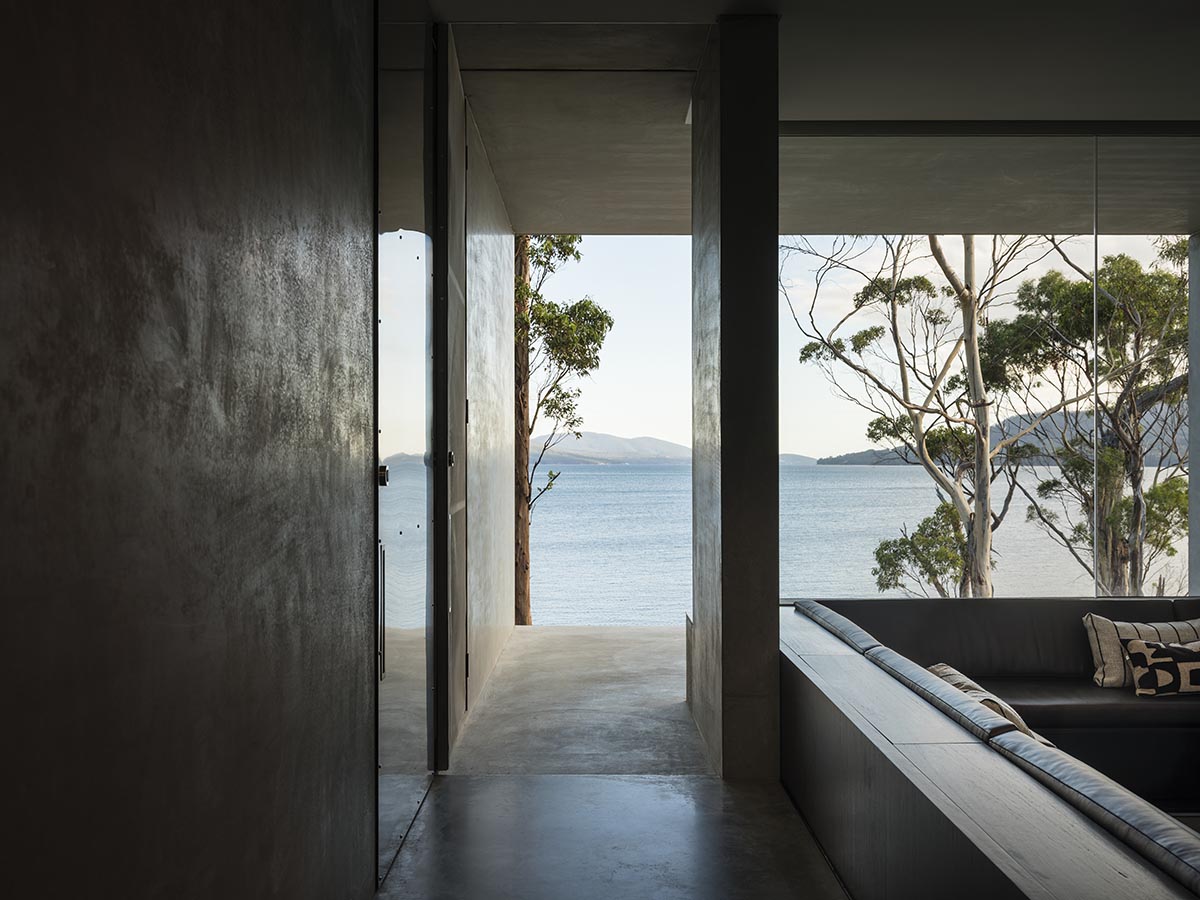 A linear, concrete tunnelled guest house by Room11 architects extends to Tasmania’s bushlands