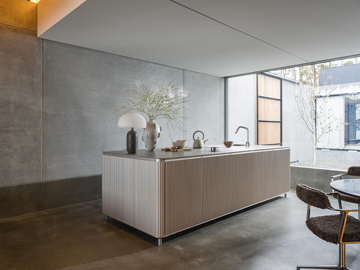 A linear, concrete tunnelled guest house by Room11 architects extends to Tasmania’s bushlands