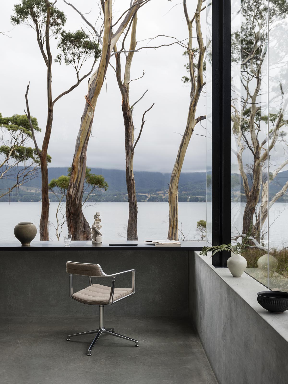 A linear, concrete tunnelled guest house by Room11 architects extends to Tasmania’s bushlands