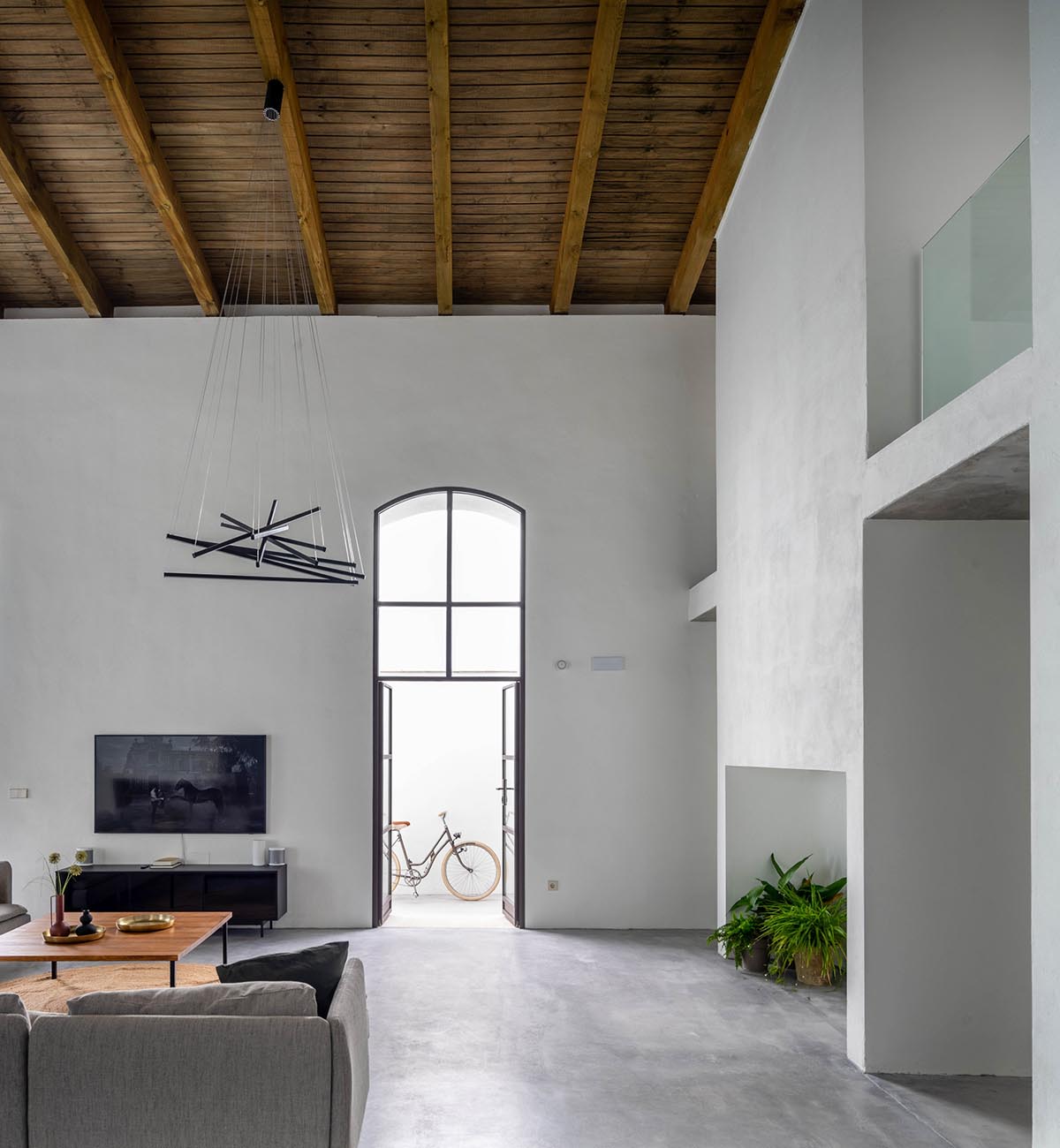 Iniesta Nowell Arquitectos converts old warehouse into house with a network of service alleys