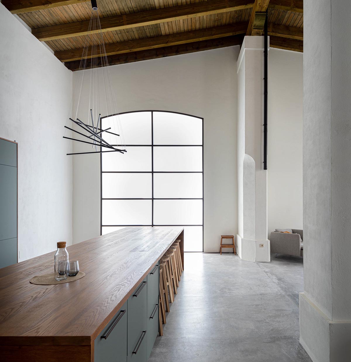 Iniesta Nowell Arquitectos converts old warehouse into house with a network of service alleys
