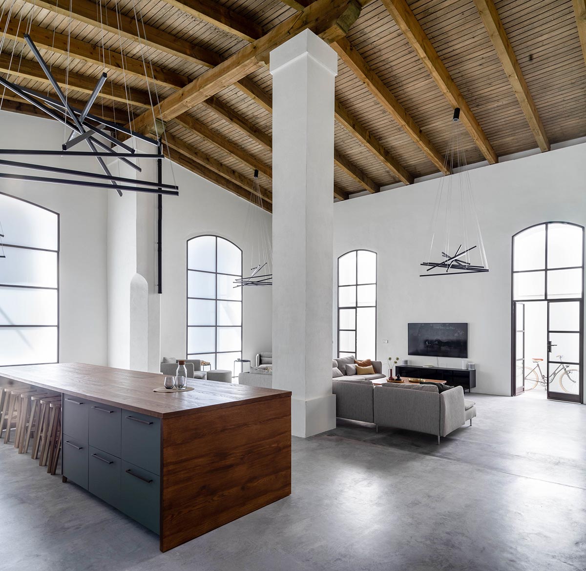 Iniesta Nowell Arquitectos converts old warehouse into house with a network of service alleys