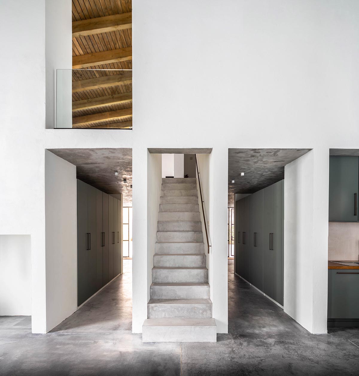 Iniesta Nowell Arquitectos converts old warehouse into house with a network of service alleys