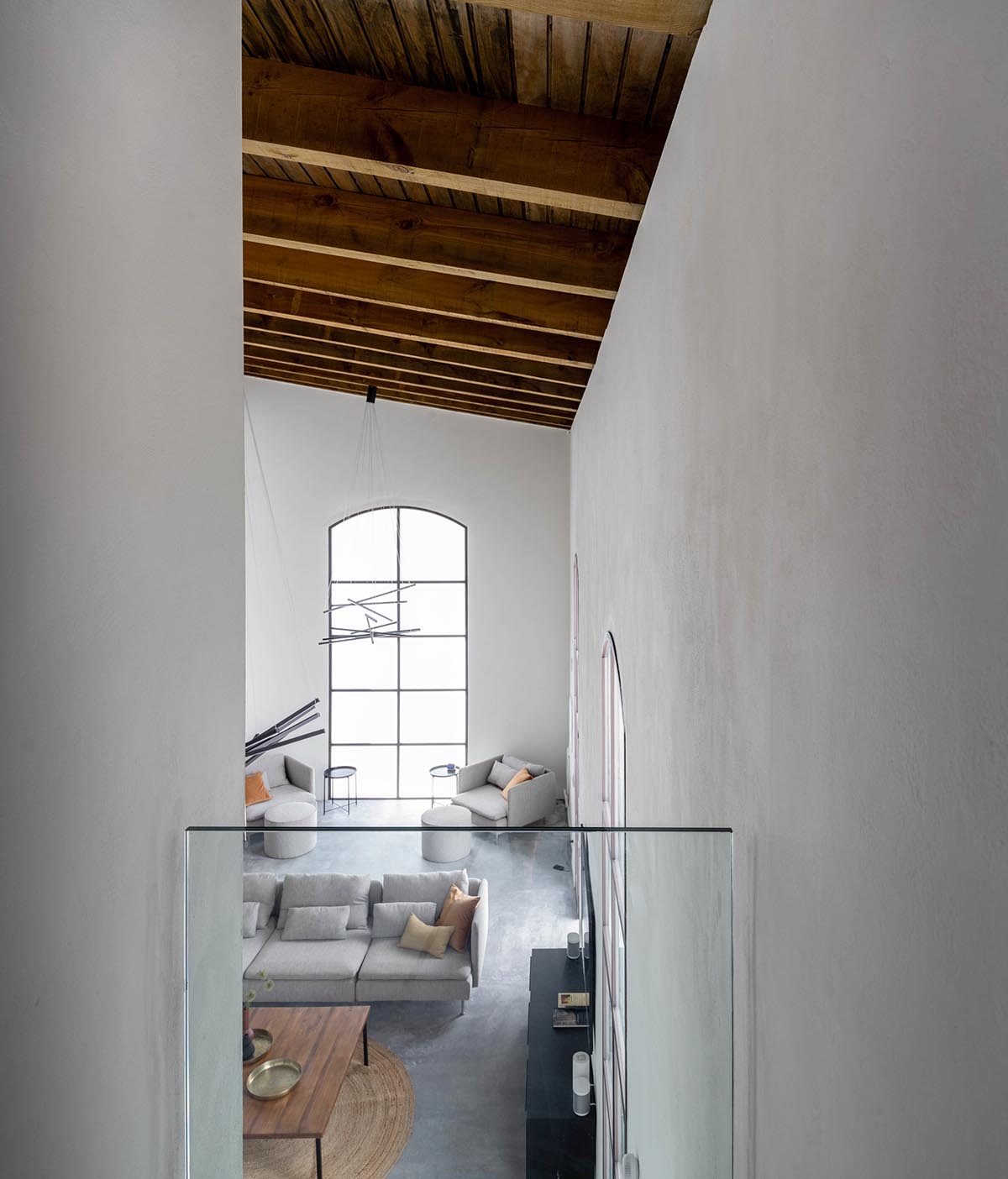 Iniesta Nowell Arquitectos converts old warehouse into house with a network of service alleys