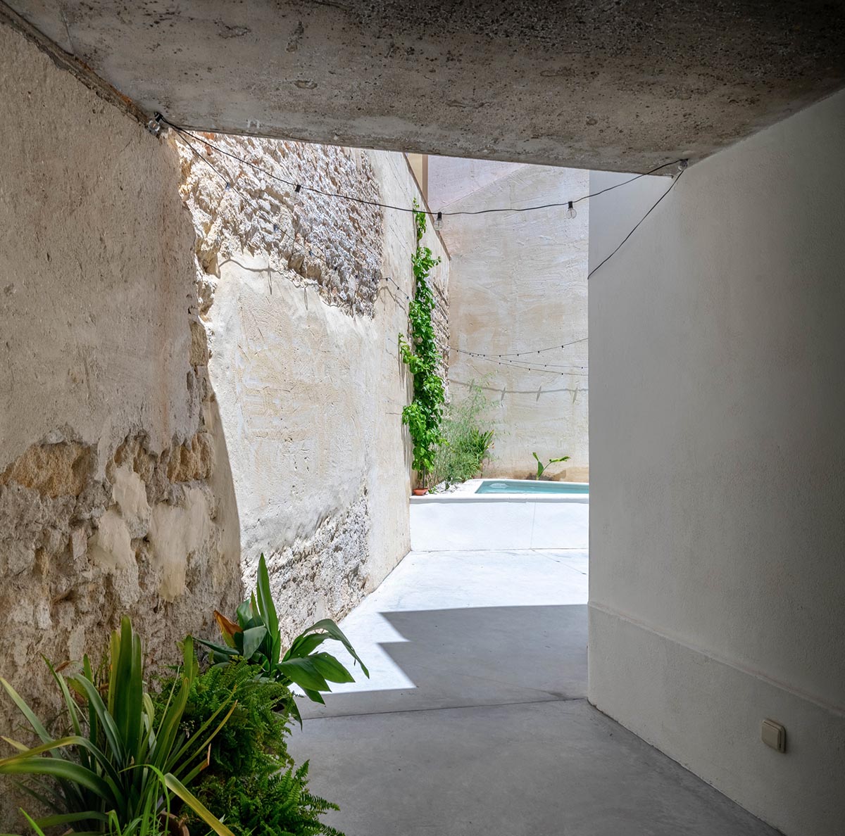Iniesta Nowell Arquitectos converts old warehouse into house with a network of service alleys