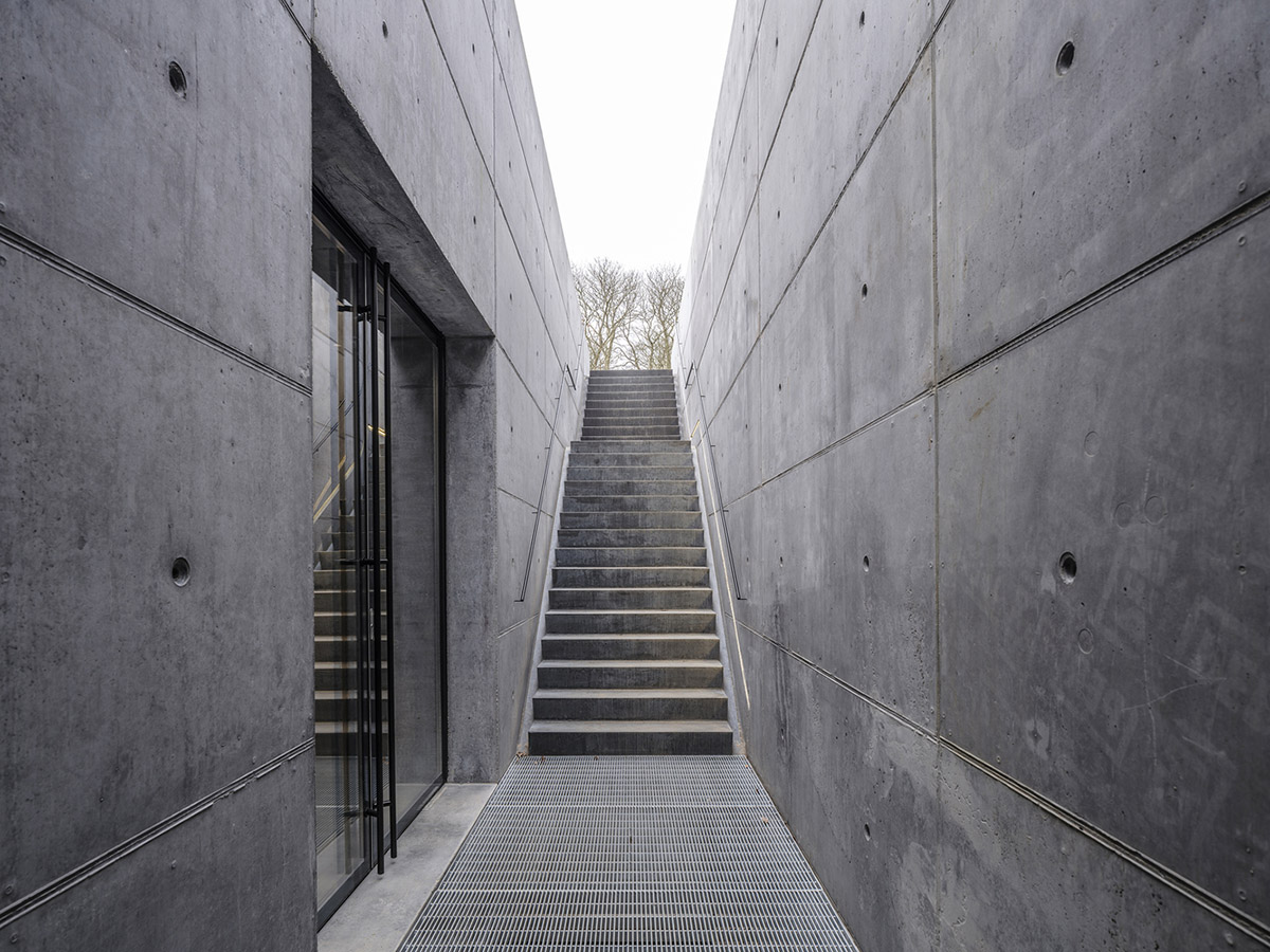 Inbo BV redesigns historic prisoner camp site with reflective pavilion and underground museum