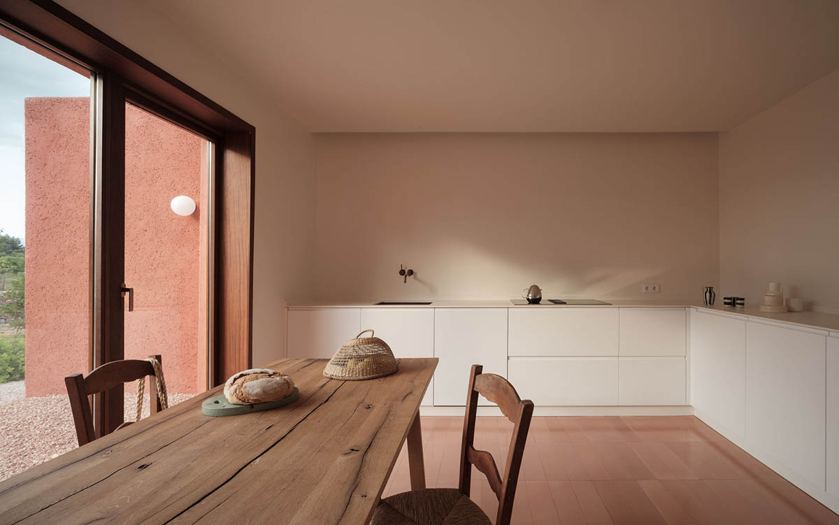 Large openings and reddish-colored façades mark this holiday home by Isla Architects in a rustic land