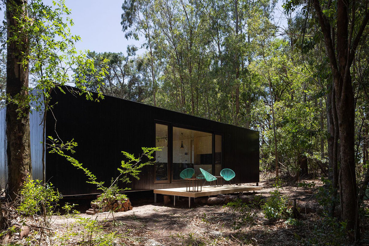 Black wooden cabin by iHouse estudio is an off-grid escape home in Uruguayan native forest