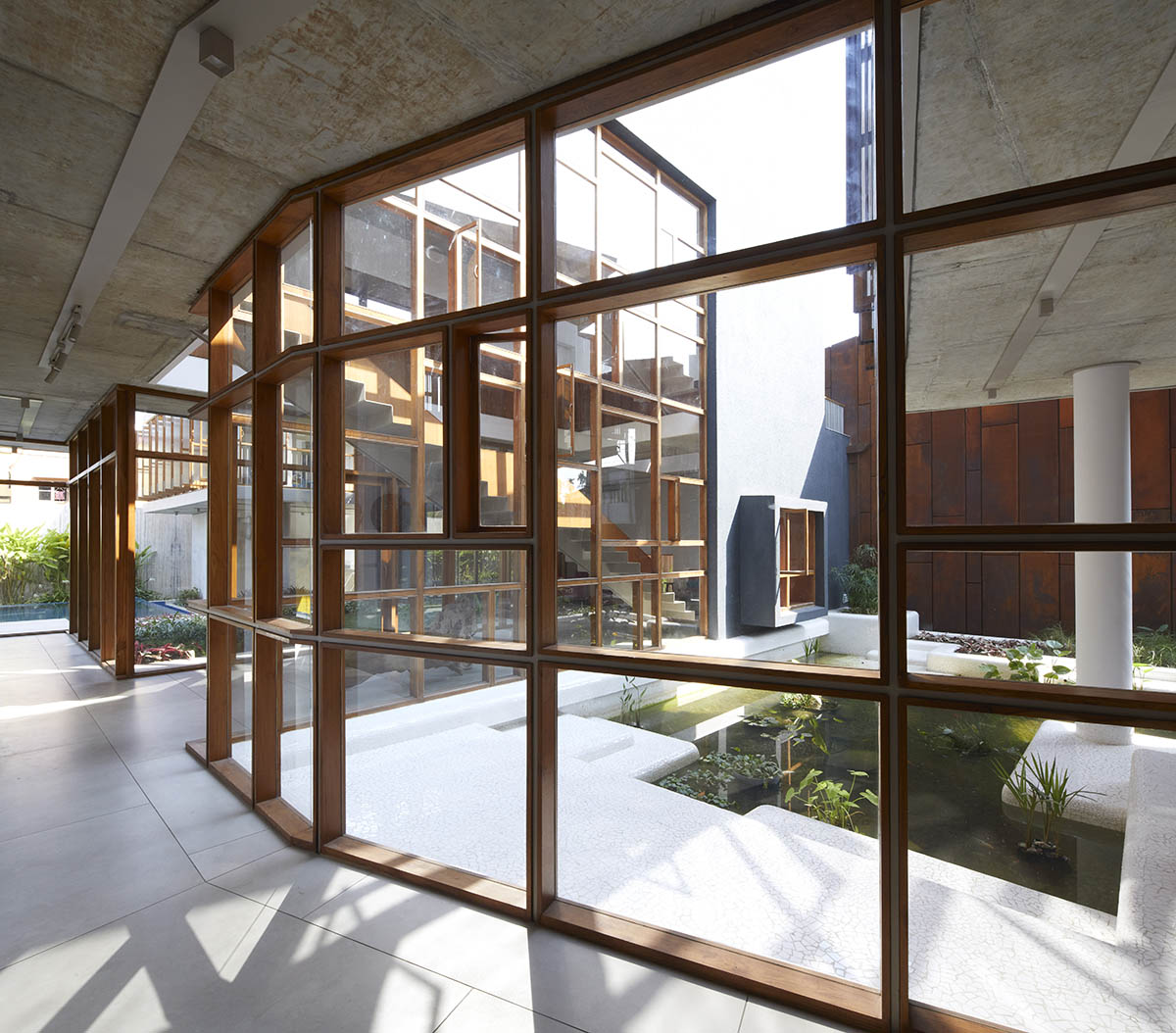 12-foot-tall weathered steel wall ensures privacy and noise-free house in India by Abin Design Studio