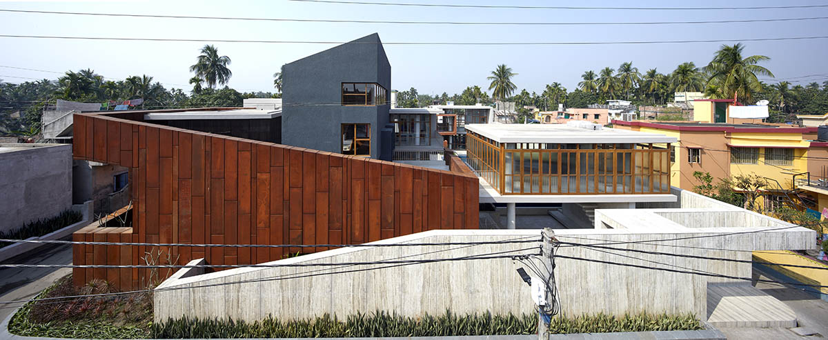 12-foot-tall weathered steel wall ensures privacy and noise-free house in India by Abin Design Studio