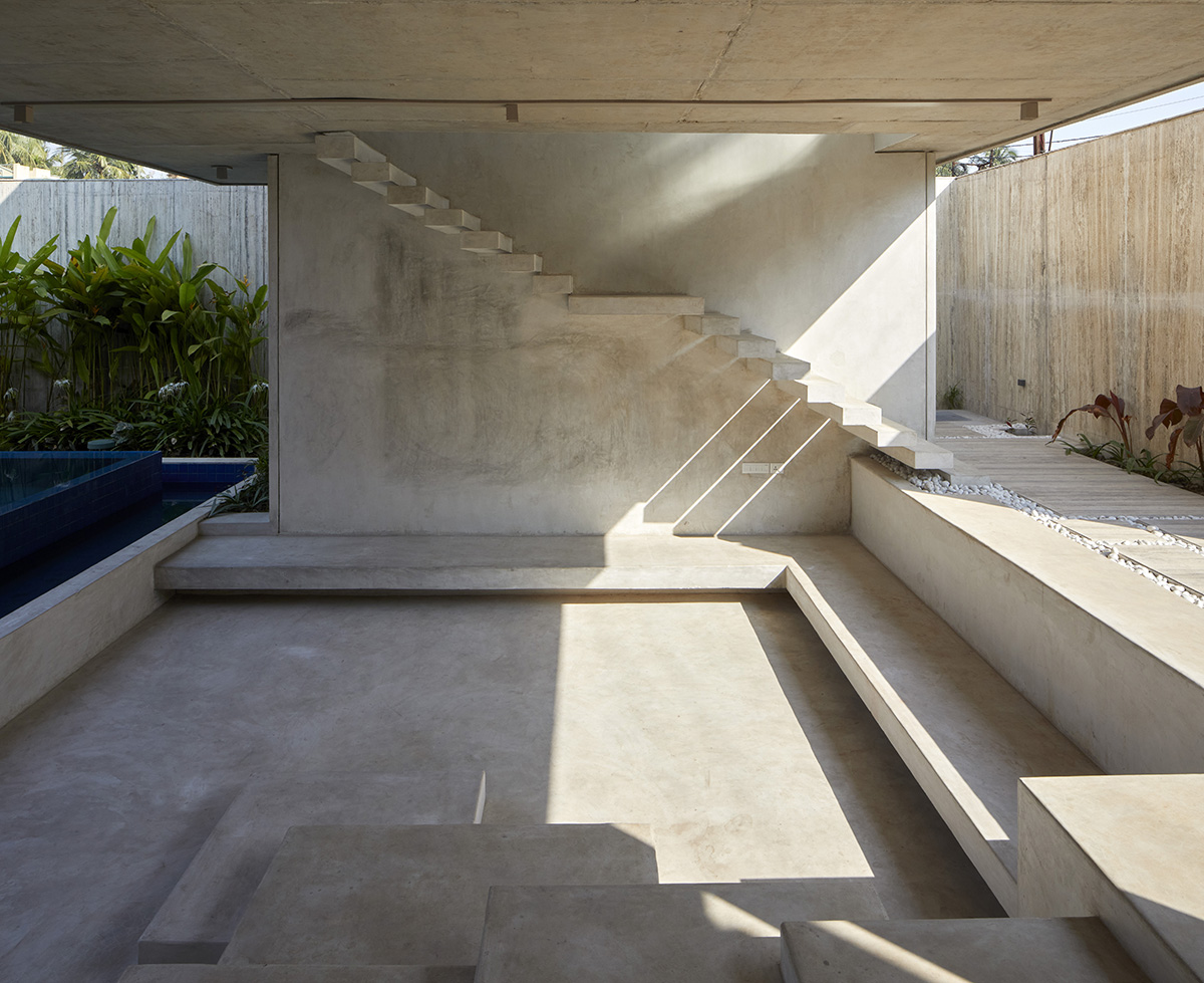 12-foot-tall weathered steel wall ensures privacy and noise-free house in India by Abin Design Studio