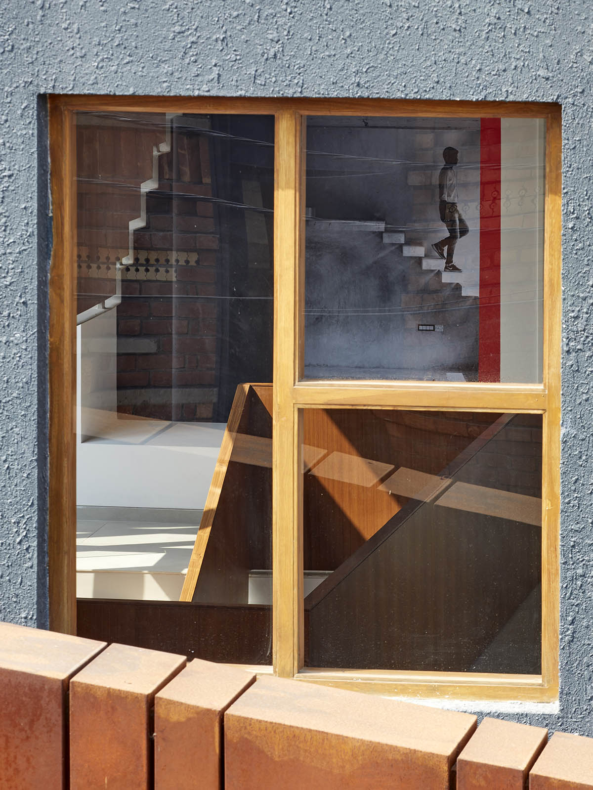 12-foot-tall weathered steel wall ensures privacy and noise-free house in India by Abin Design Studio