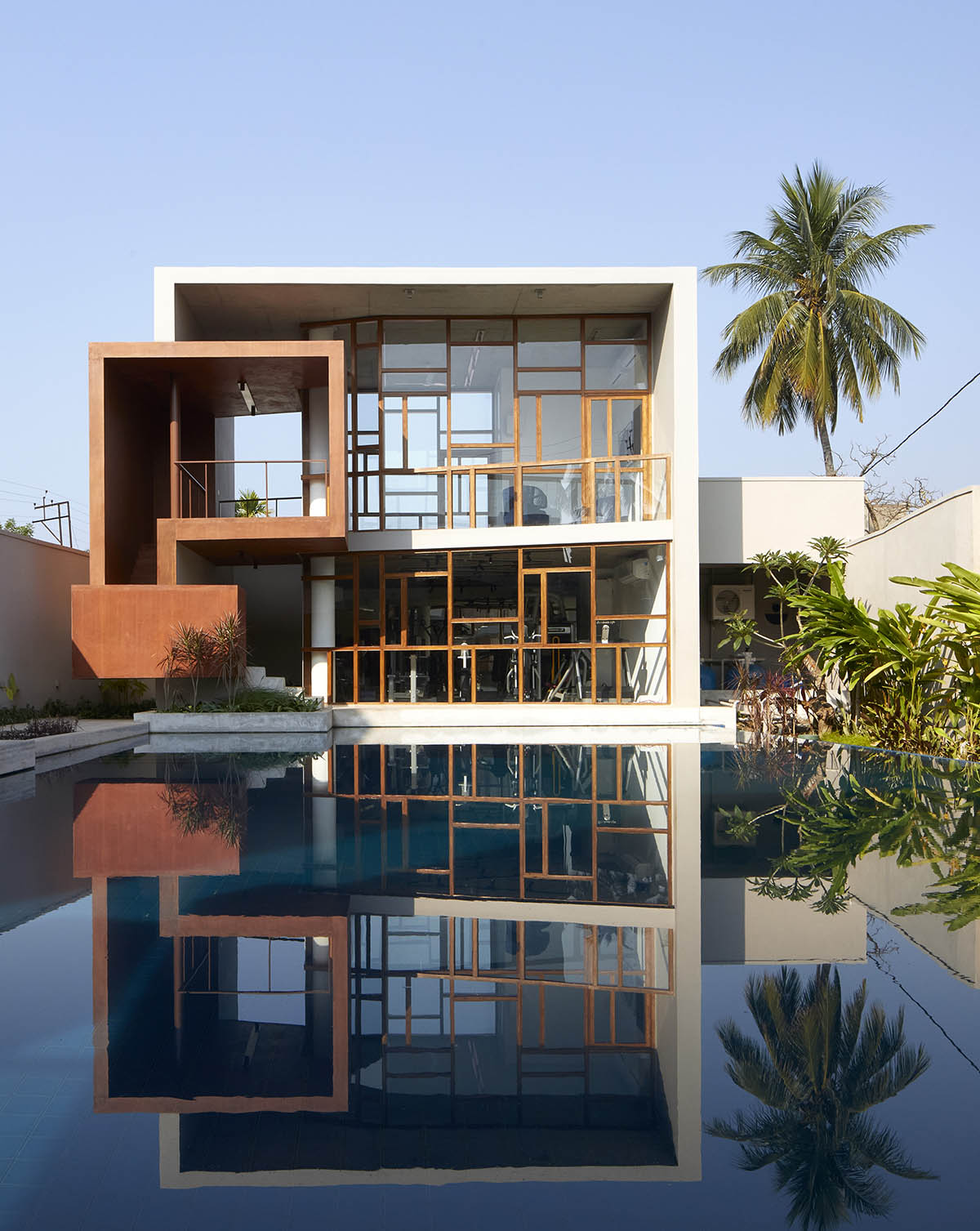 12-foot-tall weathered steel wall ensures privacy and noise-free house in India by Abin Design Studio