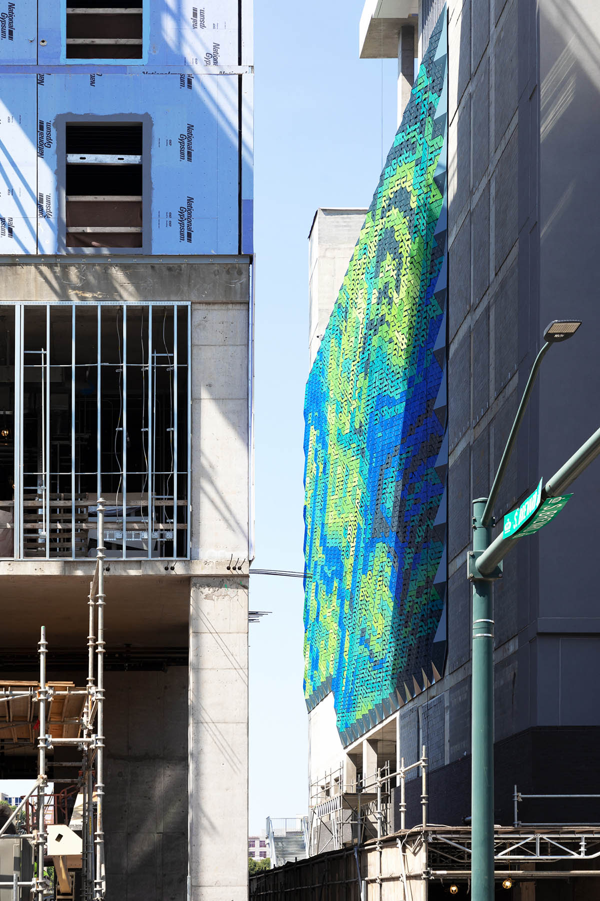 THEVERYMANY designed a dynamic and porous skin that wraps the facade of a garage in North Carolina