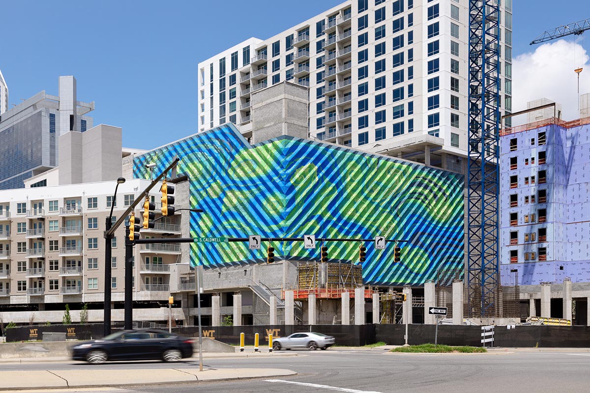 THEVERYMANY designed a dynamic and porous skin that wraps the facade of a garage in North Carolina