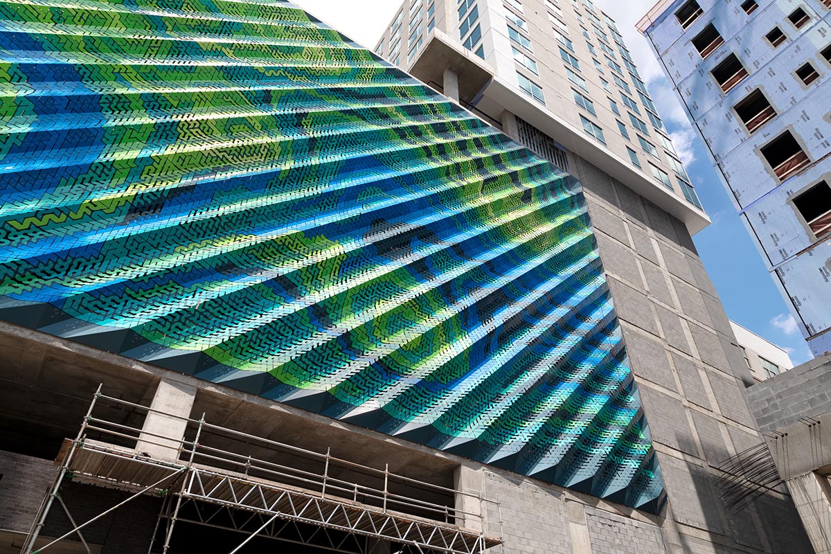 THEVERYMANY designed a dynamic and porous skin that wraps the facade of a garage in North Carolina