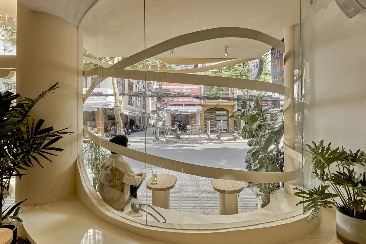 September Cafe is designed to look like a bird's nest with curved steel stripes in Vietnam