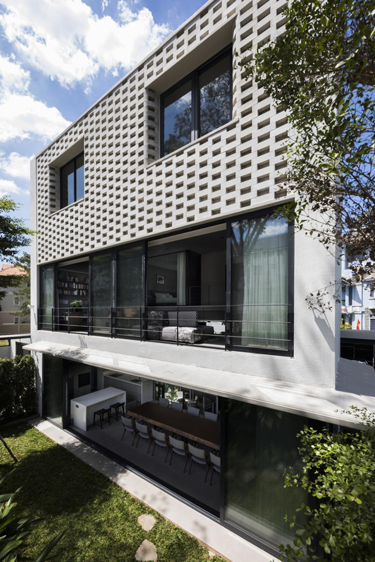 Nha Dan Architects built this house with porous facade to provide maximum thermal comfort in Vietnam
