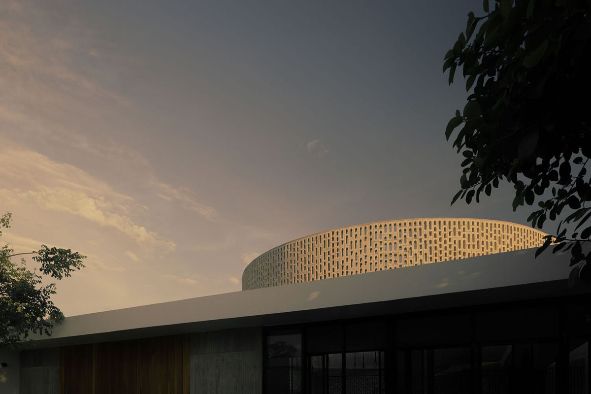 Perforated walls and cylindrical courtyard provide play of light in Wóolis House in Mexico