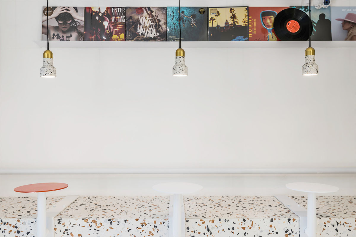 This tiny cafe by TOUCH Design is dotted with white and orange interwoven terrazzo details in Tianjin