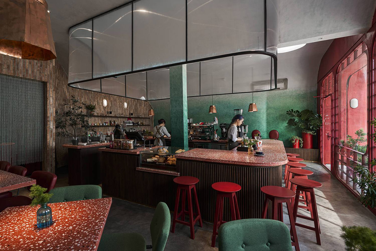 Red5studio built cafe evoking a retro spirit with hues of red colors and lights in Vietnam