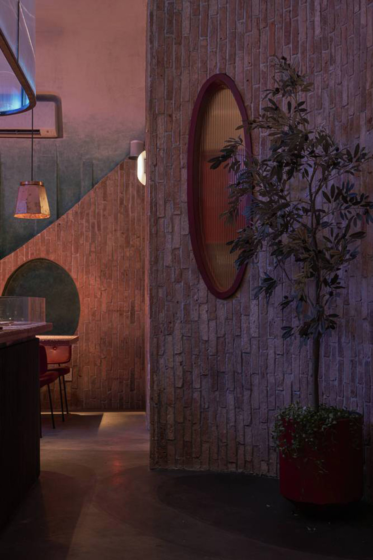 Red5studio built cafe evoking a retro spirit with hues of red colors and lights in Vietnam