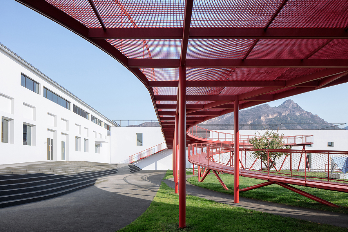 REDe Architects and Moguang Studio add red circular platform to renovated youth activity center