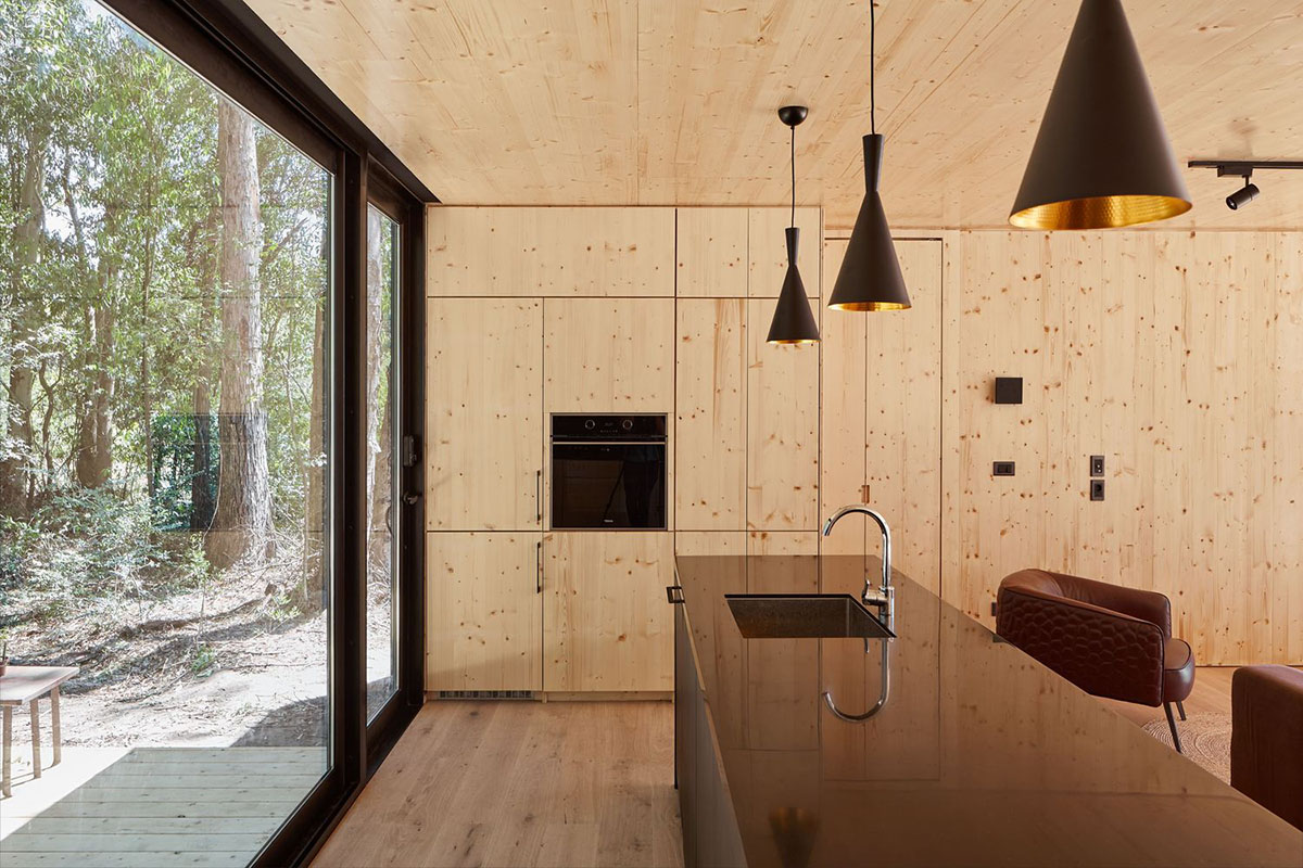 Black wooden cabin by iHouse estudio is an off-grid escape home in Uruguayan native forest
