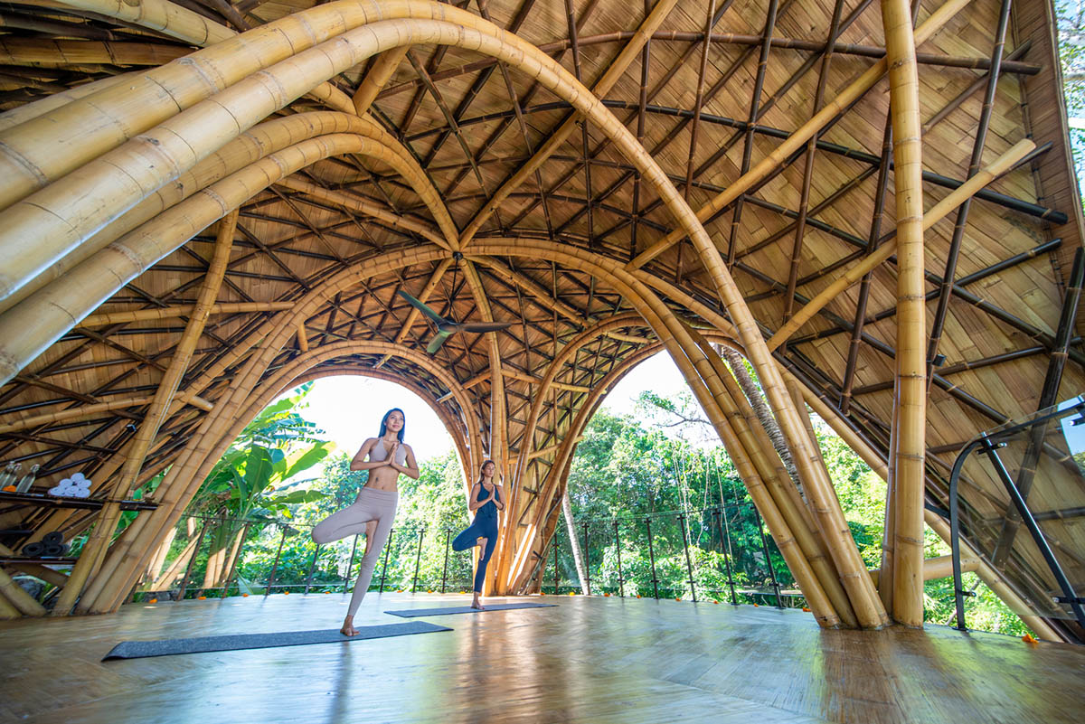 Undulating bamboo roofs wrap this wellness retreat in a lush forest of Bali