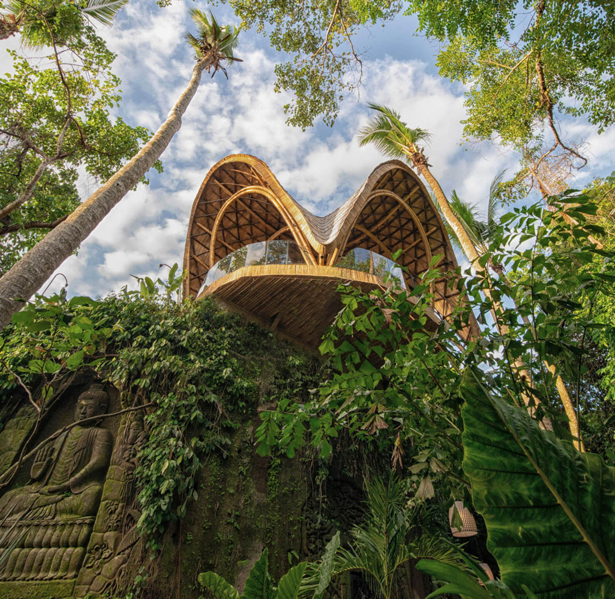 Undulating bamboo roofs wrap this wellness retreat in a lush forest of Bali