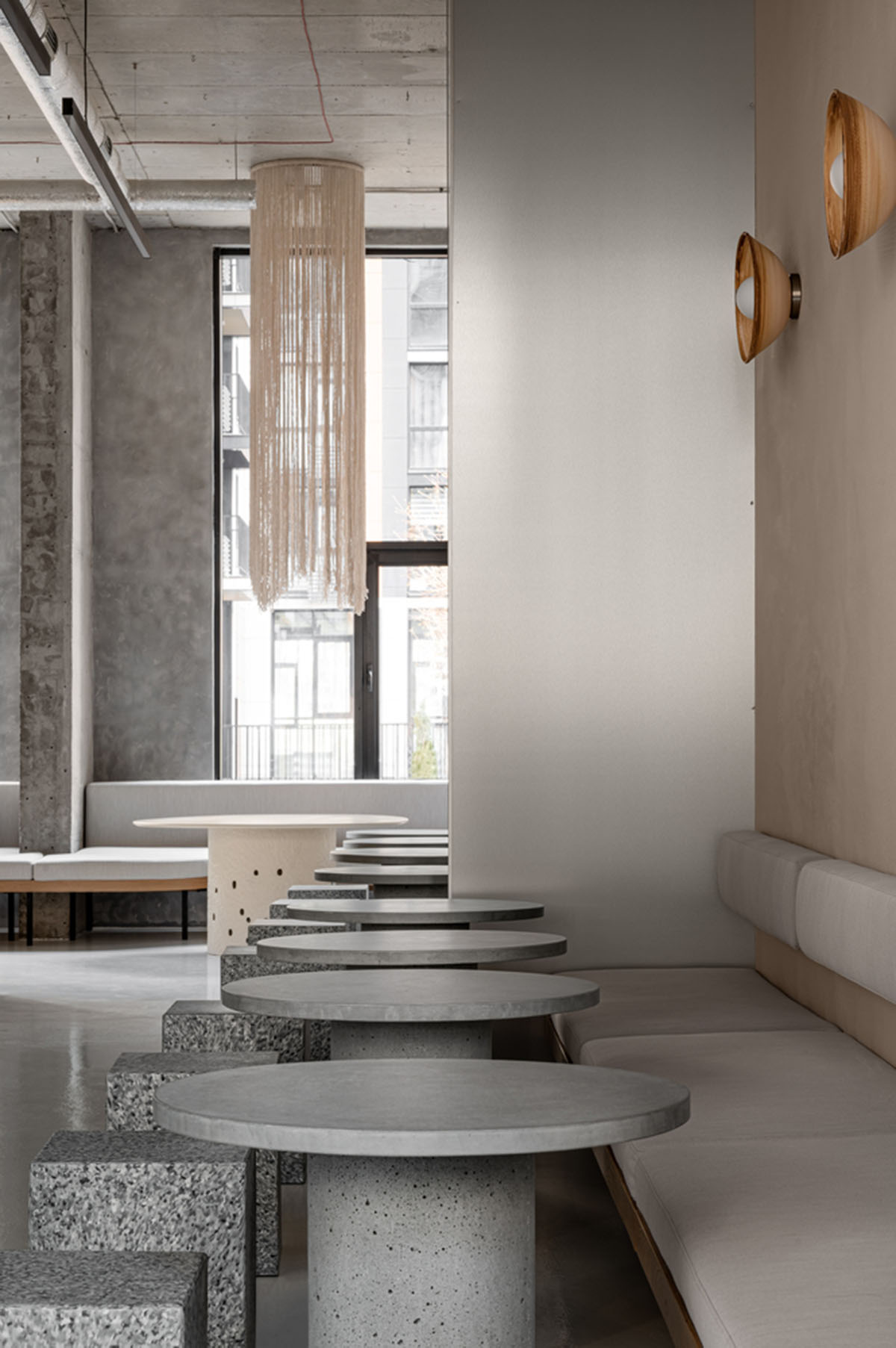 Earth-toned materials and soft lines form interiors of this ready-to-eat food restaurant in Kyiv