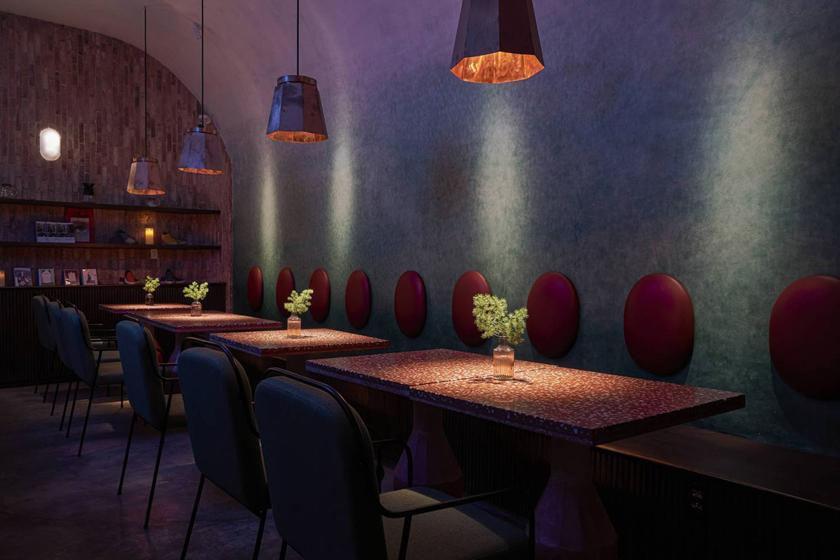 Red5studio built cafe evoking a retro spirit with hues of red colors and lights in Vietnam