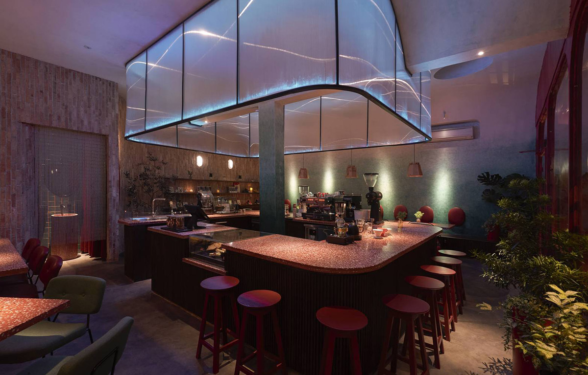 Red5studio built cafe evoking a retro spirit with hues of red colors and lights in Vietnam