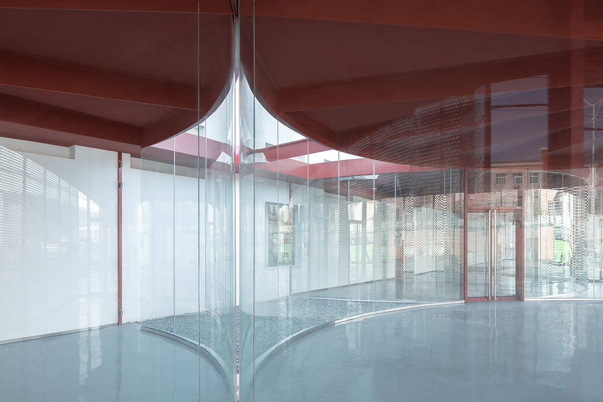 REDe Architects and Moguang Studio add red circular platform to renovated youth activity center