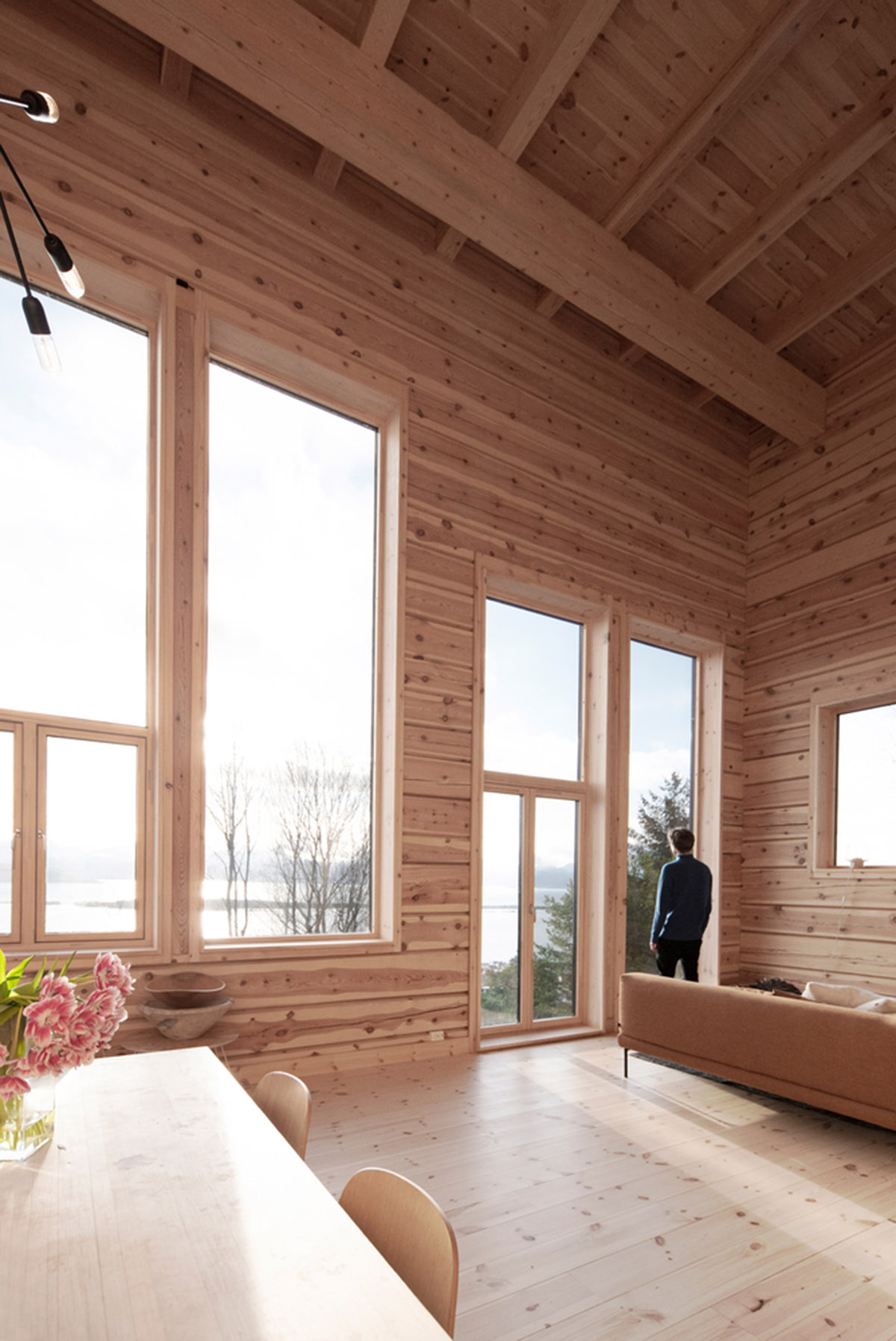 High windows allow users to get well-lit living spaces for this house by Rever & Drage Architects