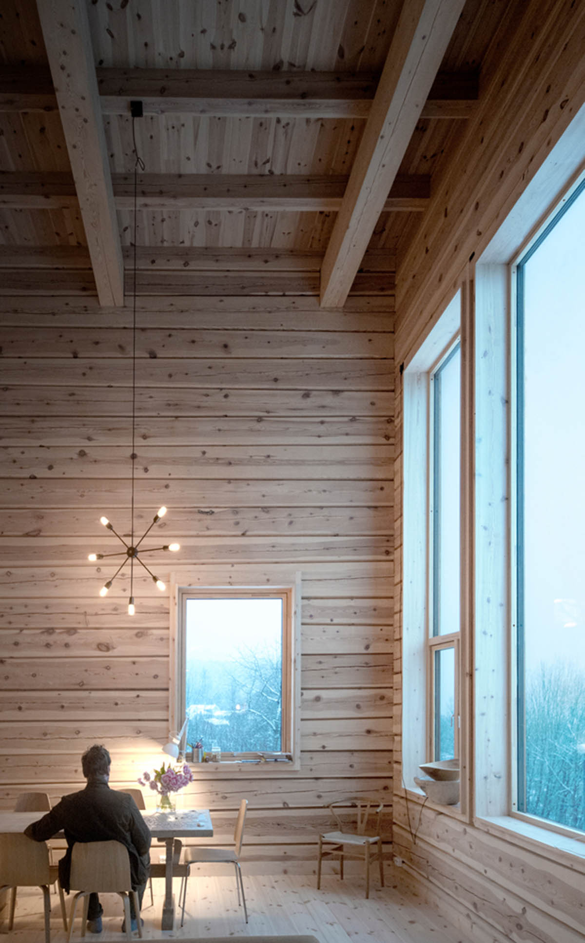 High windows allow users to get well-lit living spaces for this house by Rever & Drage Architects