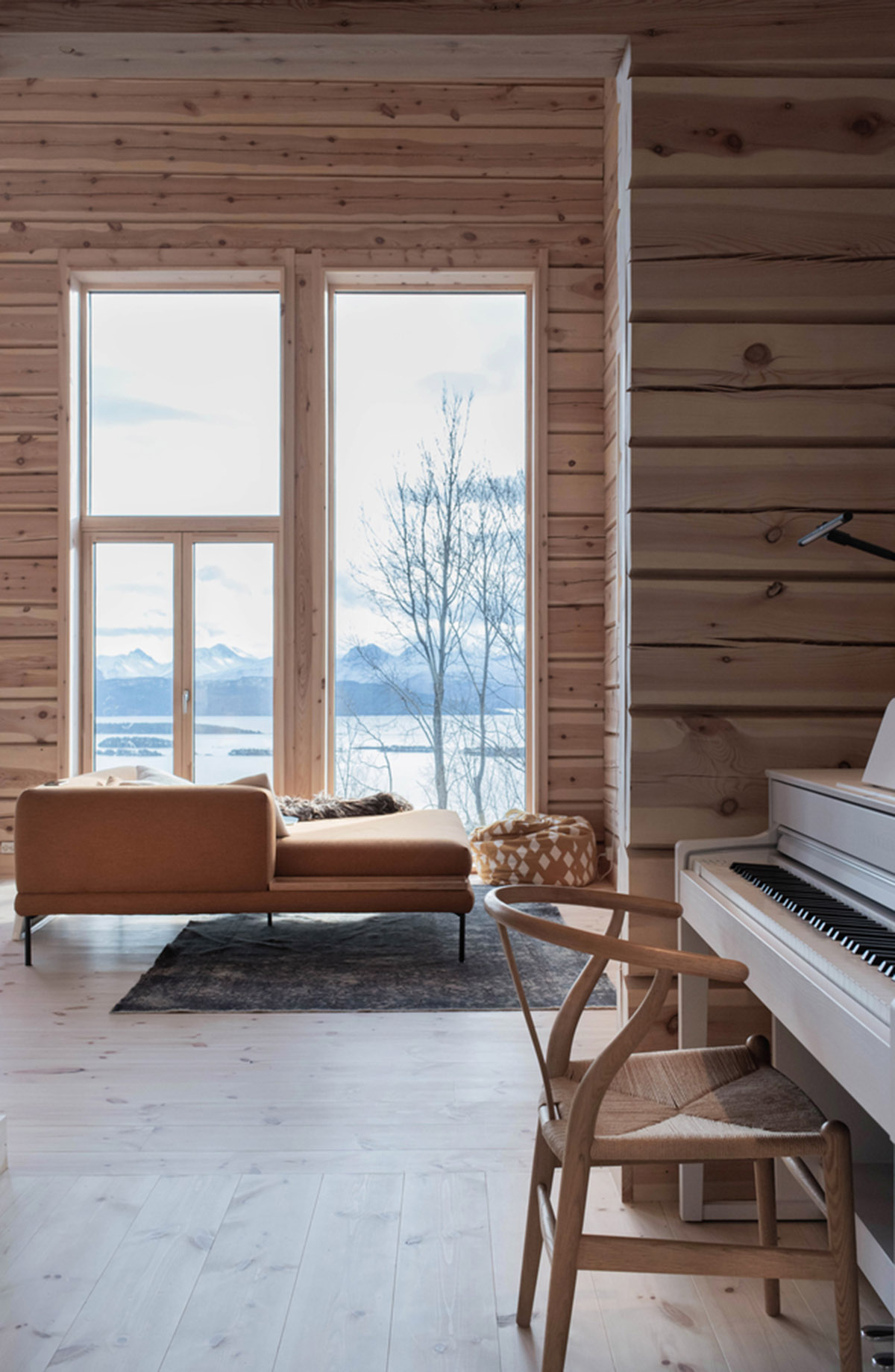 High windows allow users to get well-lit living spaces for this house by Rever & Drage Architects