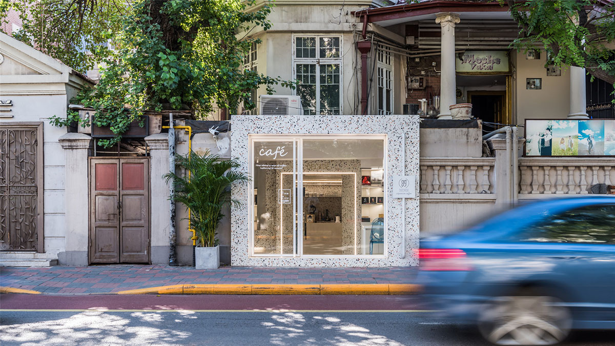 This tiny cafe by TOUCH Design is dotted with white and orange interwoven terrazzo details in Tianjin