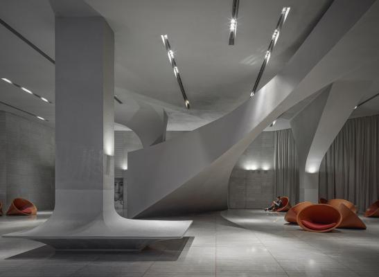 Greyscale interior provides acoustically comfortable space for a cinema by  One Plus Partnership